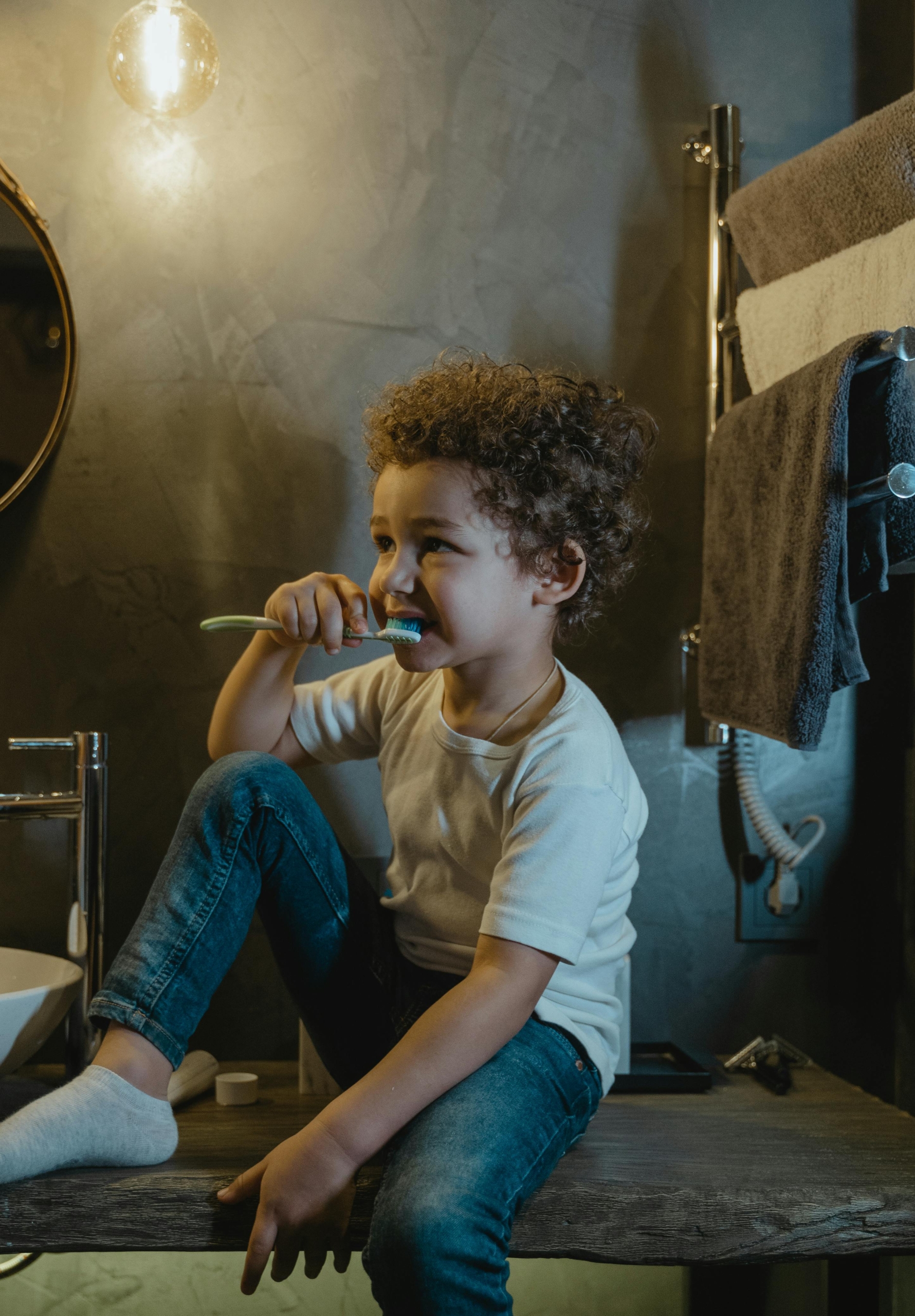Child Brushing teeth in bathroom